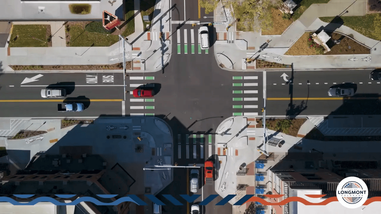 Aerial view of a protected intersection in Longmont showing corner islands, green bike crossings, pedestrian crosswalks and vehicle lanes.